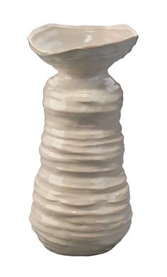 a white vase sitting on top of a table