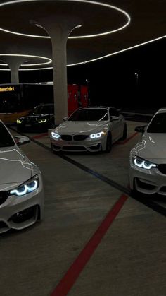 three cars parked in a parking garage at night