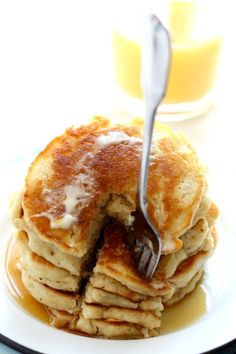 a stack of pancakes with syrup being drizzled on top