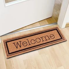 a welcome mat on the floor in front of a door that says,'welcome '