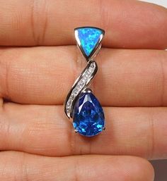 "Brand new high quality sterling silver slide pendant with lab created blue Inlay Fire Opal, a 9x12mm (3 carats) faceted pear London Blue Topaz, and CZ stones. The pendant measures 1-1/4\" long and 1/2\" wide. Our silver is genuine 925 solid sterling silver and rhodium plated for better quality and prolonged shine. You will receive the item in a gift box. Thanks for looking and check out more items in my Etsy shop for more great items and deals! https://www.etsy.com/shop/925usa Payment: We accep Blue Fire Opal, Map Pendant, Wedding Gifts For Bride, Disc Pendant, Silver Lake, Blue Fire, 3 Carat, London Blue Topaz, London Blue