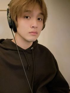 a young man wearing headphones while sitting down