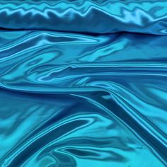 a blue satin fabric with wavy lines on the top and bottom, as well as an image