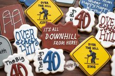 decorated cookies that say it's all downhill from here to forty and over the hill