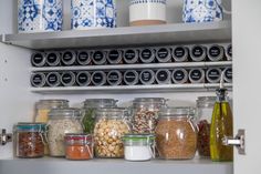 an organized pantry filled with jars and containers full of different types of food, including nuts