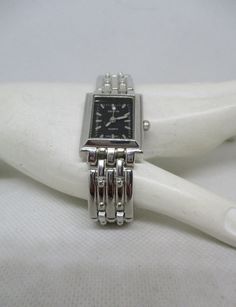 "*New Battery Installed Prior Shipping.* *2 Watches Available* *Share with Family Member Or Friends.* This is a never worn Geneva quartz woman's watch that has a rectangular silver-tone metal watch case with a black face, silver-tone metal bars representing numbers, and three \"Glow-In-The-Dark Hands.* The watch band is made out of silvertone metal vintage links. The back of the watch is stainless steel.  Watch Case Length 1 inch. Watch Case Width 12/16 inch. Watch Band Length including clasp 7 Black Face Watch, Handwritten Gifts, Pendant Watches, Watch New, Pretty Bracelets, Metal Bar, Women Wrist Watch, Beautiful Watches, Women's Watch