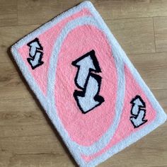 a pink and white rug with arrows on it