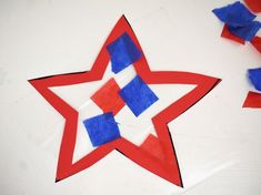 a red, white and blue paper star next to confetti