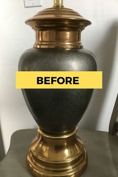 a black and gold urn sitting on top of a table