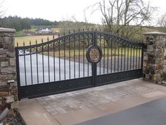 an iron gate is open to the driveway