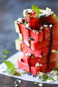 watermelon salad with balsamic and feta cheese on top is shown