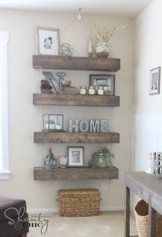 some shelves in a living room with pictures on them