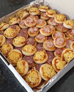 an open box filled with lots of different types of appetizers and toppings