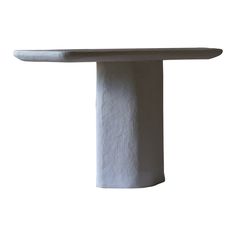 a white table that is made out of concrete