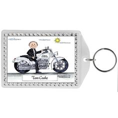 a keychain with a photo of a man on a motorcycle and the words, tom corbe