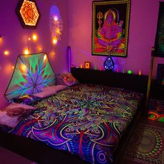 a bed covered in lots of colorful lights next to pictures on the wall above it