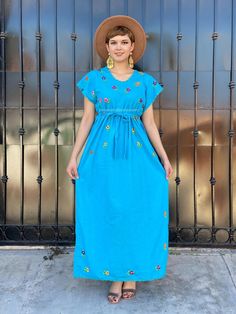 "Vintage turquoise mexican dress, mini floral embroidery, blue maxi dress, boho hippie kaftan, 90s mexico dress, blue latina tunic, coco Gorgeous vintage Mexico dress made in the 90's. Bright and colourful, hand-embroidered flowers. Accents on the neck and sleeves in crochet. Color: Turquoise Fabric: Cotton It comes with a cotton belt, to show your waist, on one side at the bottom of the dress has a small opening (shown in picture #8) Fits size Medium Measurements taken flat: Armpit to armpit 21 Embroidered Blue Maxi Dress For Summer, Blue Floral Embroidered Beach Dress, Blue Floral Embroidered Dress For Beach, Turquoise Spring Sundress Maxi Dress, Blue Maxi Boho Dress For Festivals, Blue Floral Embroidery Dress For Beach, Turquoise Sundress For Spring, Spring Fiesta Embroidered Maxi Dress, Turquoise Short Sleeve Maxi Dress For Summer