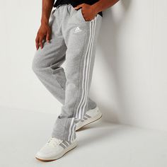 These adidas men's sweatpants were made for your comfort during workouts or lounging at home. Made from soft cotton-fleece with the brand's signature stripes and logo, these pants have an elastic-drawstring waist, side slip pockets, and a straight-leg silhouette. Style them with a t-shirt and hoodie. Front Style: Flat FrontFeatures: DrawstringClosure Type: Full Elastic, DrawstringFit: Regular FitPockets: 2 Side Slip PocketsRise: At WaistFiber Content: 78% Cotton, 22% PolyesterFabric Description… Adidas Cotton Gym Pants, Athleisure Sweatpants With Three Stripes For Gym, Adidas Athleisure Joggers For Loungewear, Adidas Cotton Sweatpants For Gym, Adidas Cotton Joggers For Gym, Adidas Sweatpants For Loungewear, Athleisure Style, Cotton Activewear With Three Stripes In Relaxed Fit, Adidas Sweatpants For Loungewear In Athleisure Style, Adidas Sweatpants For Loungewear