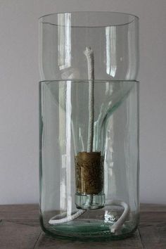 a glass vase with a white cord in it