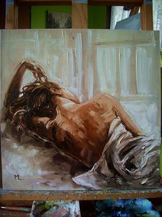 a painting of a naked woman laying on the floor