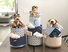 three stuffed animals are sitting on top of some containers