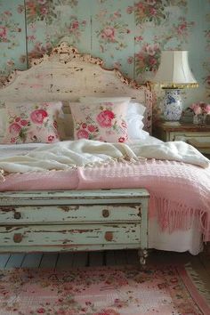 a bedroom with floral wallpaper and white bedding, pink flowers on the headboard