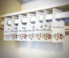 four white door hangers with floral designs on them hanging from a hook in a closet