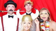 three people dressed up in costume posing for a photo with horns on their heads and nose