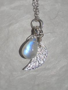 - Made with flashy beautiful moonstone and sterling silver angel wing charm. - Moon stone is about 10 mm in length. - The pendant can slide in and out of the necklace chain. - Sterling silver findings are used. - The chain is available in 1.4 mm thickness (chain shown in the photos of this listing) or 1.6 mm thickness (a little thicker chain). - Please specify the length, chain thickness, and 2 inch extender option during checkout. 2 inch extender is available for a little extra cost if you want White Labradorite Necklace As Gift, White Labradorite Necklace For Gift, Moon Necklace Silver, Silver Angel Wings, Angel Wing Necklace, Silver Wings, Wing Necklace, Chunky Jewelry, June Birthstone