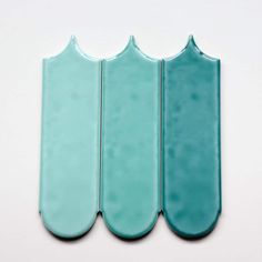 three pieces of blue glass sitting next to each other