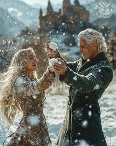 a man and woman standing in the snow