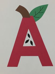 the letter a is made out of paper and has leaves on it