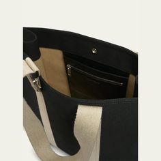 Jacquemus wool canvas tote bag with contrasting grosgrain in a structured construction  Flat top handles Open top with a snap closure  Engraved square carabiner Back patch pocket Interior double-zipped pocket  Approx. 15.4"H x 5.1"W  Made in Italy Classic Black Canvas Bag, Modern Canvas Bag With Handles, Luxury Black Canvas Bag For Everyday, Black Double Handle Bag With Canvas Lining, Luxury Black Canvas Bag With Leather Handles, Functional Canvas Shoulder Bag With Handles, Black Rectangular Satchel With Canvas Lining, Luxury Black Canvas Bag, Modern Black Canvas Bag With Top Handle