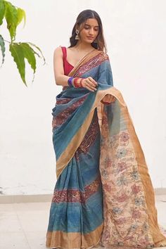 Indigo saree featuring kalamkari patterned blossom motifs highlighted by woven golden border and sequin embellishments. Comes with unstitched blouse fabric. - Aza Fashions Bohemian Chanderi Pre-draped Saree For Navratri, Bohemian Cotton Silk Pre-draped Saree, Festive Bohemian Pre-draped Tussar Silk Saree, Designer Tussar Silk Pre-draped Saree With Printed Border, Bohemian Pre-draped Saree With Zari Work, Blue Raw Silk Saree With Kalamkari Print, Fitted Chanderi Saree With Kalamkari Print, Pre-draped Tussar Silk Saree With Kalamkari Print, Festive Kalamkari Print Pre-draped Saree In Slub Silk