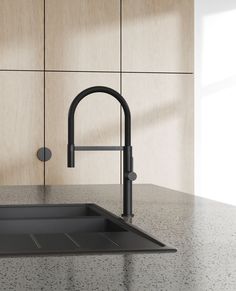 a black kitchen sink sitting under a faucet