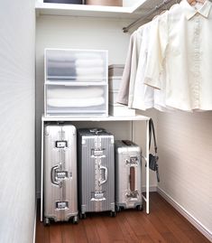 two suitcases are sitting next to each other on the floor in front of a closet