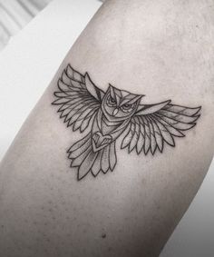 an owl tattoo on the arm