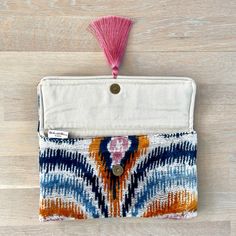 a small pouch with a tasseled handle