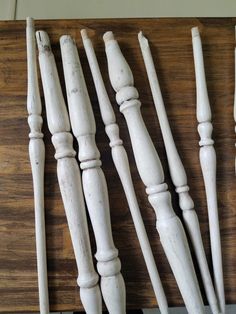 several white wooden objects are lined up on a table