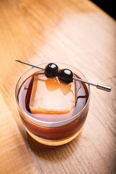 an image of a dessert in a bowl with two olives on the top and ice