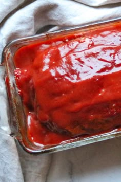 a glass casserole dish filled with red sauce