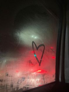 a heart drawn on the side of a car window