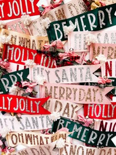 many different types of christmas signs hanging on the wall