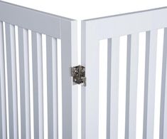 a close up of a white gate with metal latches on the top and bottom bars