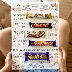 a person holding up a birthday card with chocolate bars on it's front and back