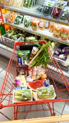 a shopping cart filled with food in a grocery store