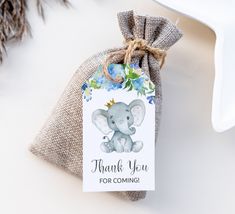 a small bag with an elephant on it and the tag says thank you for coming