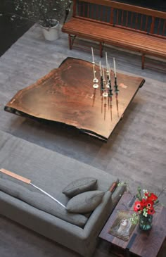 a living room with a couch, coffee table and candles on the top of it