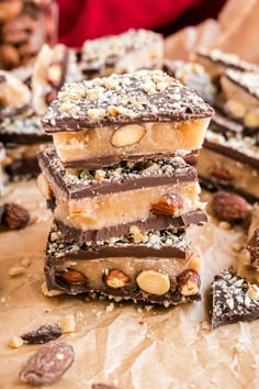 a stack of chocolate bars with nuts on top