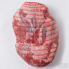 a large piece of meat wrapped in red string on a white background with the word, beef inside it